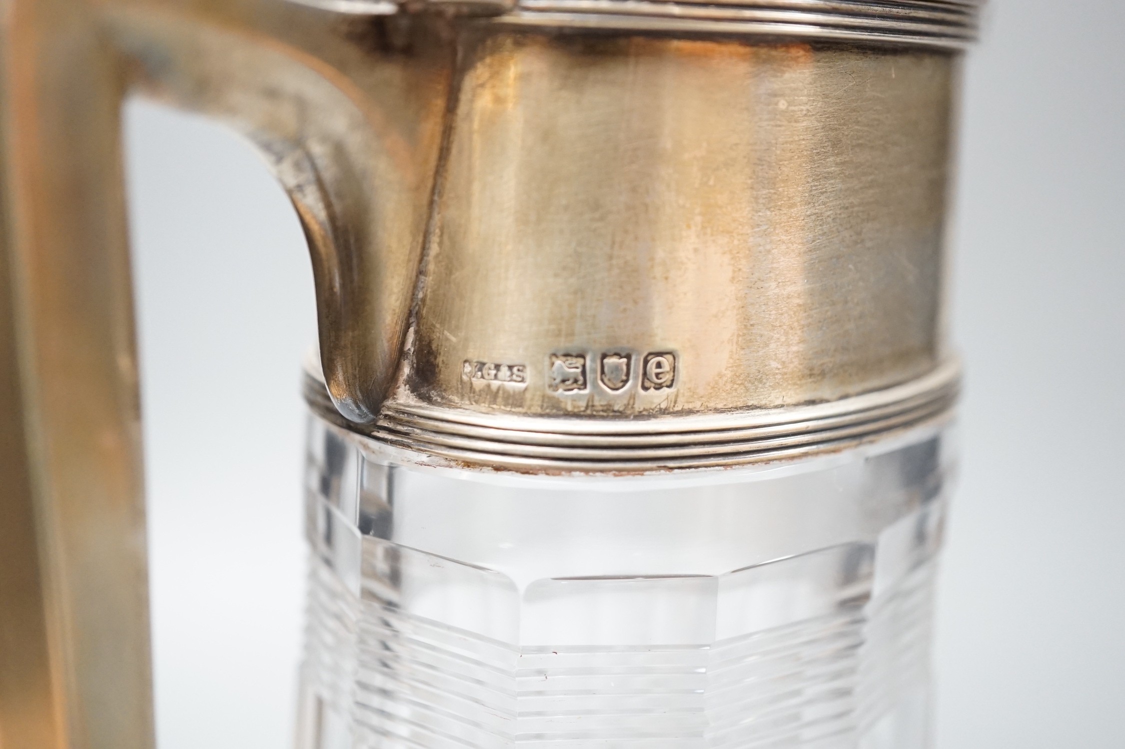A late Victorian silver mounted cut glass claret jug, with reeded bands, John Grinsell & Sons, London, 1900, 26.5cm.